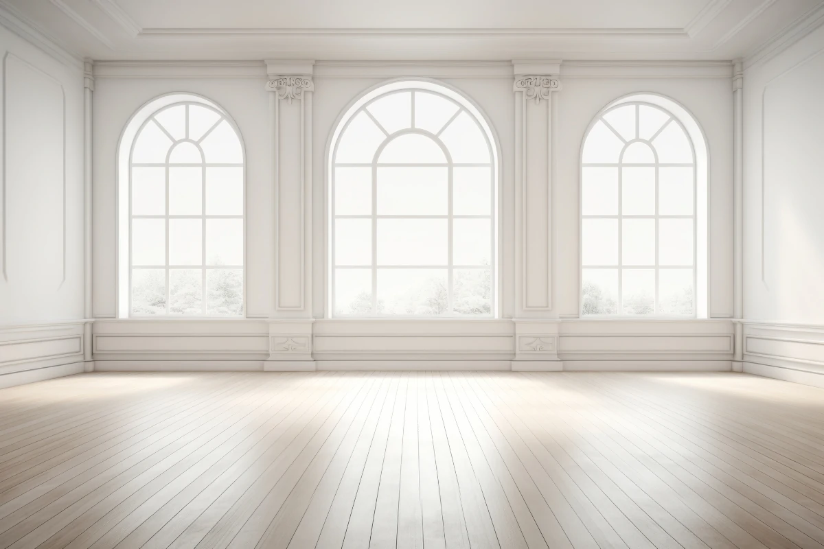 Bright interior room featuring large arched windows that maximize natural light