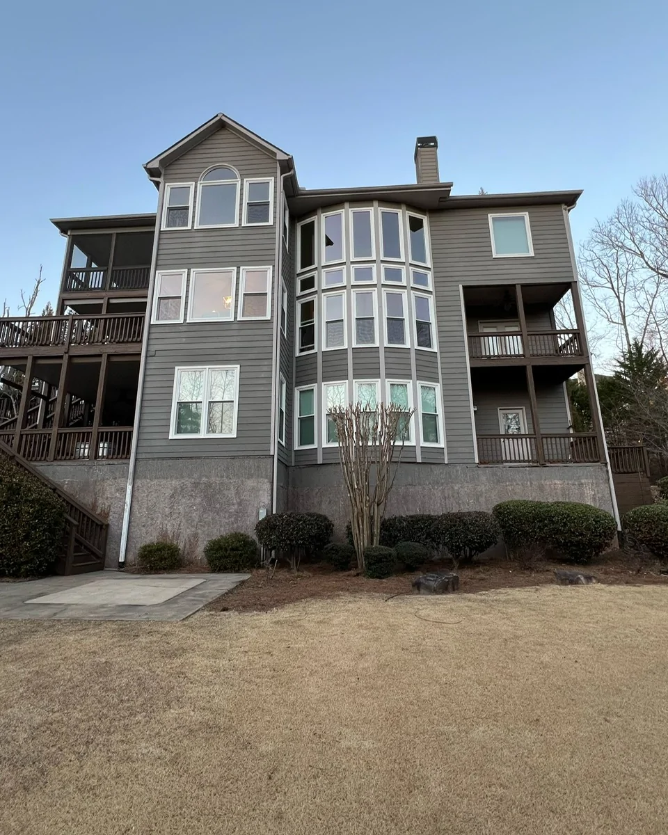 Replacement windows installed on a multi-story North Georgia home featuring picture, double-hung, and specialty windows