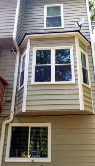 new windows on three story home wiith bay window